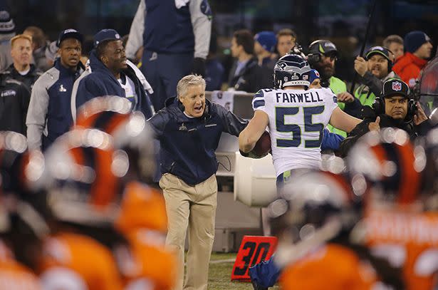 Seattle Seahawks head coach Pete Carroll, left, celebrates with Heath Farwell (55) during the second half of the NFL Super Bowl XLVIII football game against the Denver Broncos Sunday, Feb. 2, 2014, in East Rutherford, N.J. (AP Photo/Matt York)