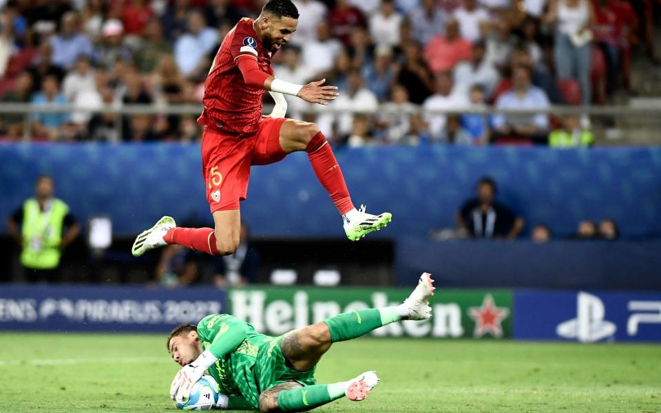 Manchester City's Brazilian goalkeeper #31 Ederson makes a save in front of Sevilla's Moroccan forward