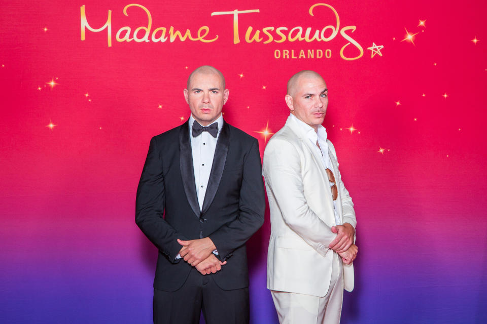 <p>Rapper Pitbull, dressed in white, keeps a straight face as he poses next to his tuxedo-clad twin.</p>