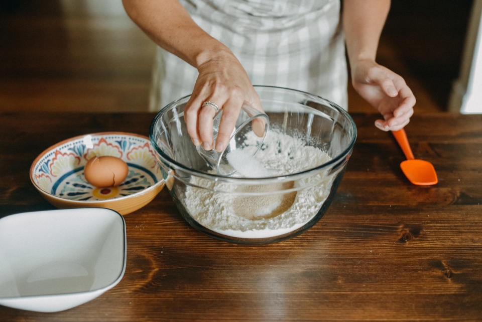 Pouring sugar into cake batter