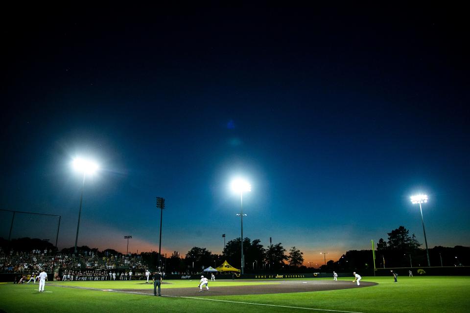 The sun sets during a Class 4A high school semifinal state baseball game between Dowling Catholic and Iowa City High, Thursday, July 21, 2022, at Duane Banks Field in Iowa City, Iowa.