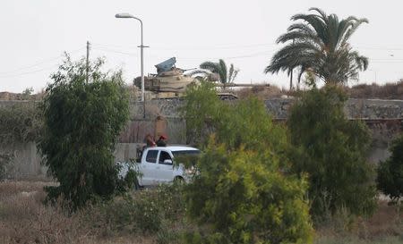 An Egyptian army tank is seen as members of Palestinian security forces loyal to Hamas patrol the border area of southern Gaza Strip with Egypt July 1, 2015 REUTERS/Ibraheem Abu Mustafa