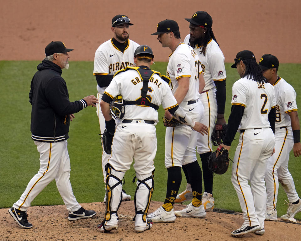 Pittsburgh Pirates manager Derek Shelton, left, takes the ball from starting pitcher Paul Skenes, center, during the fifth inning of a baseball game against the Chicago Cubs in Pittsburgh, Saturday, May 11, 2024. (AP Photo/Gene J. Puskar)
