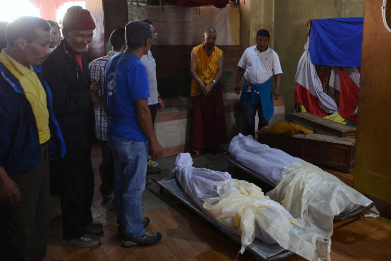 Relatives of Mount Everest avalanche victims give their last respects after the bodies were brought to the Sherpa Monastery in Kathmandu on April 19, 2014