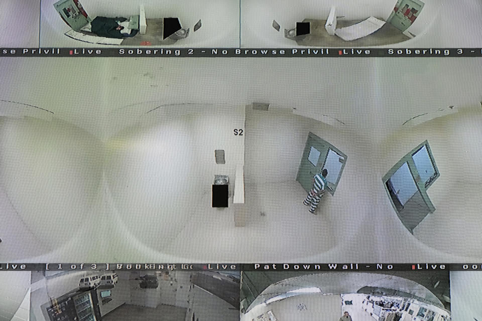 Surveillance cameras show holding cells seen on monitors in the booking area of the Lake County Jail in Lakeport, Calif., on Tuesday, April 16, 2019. At center is the holding area where a woman killed herself in 2015, leading to a $2 million settlement and a series of reforms at the jail. (AP Photo/Eric Risberg)