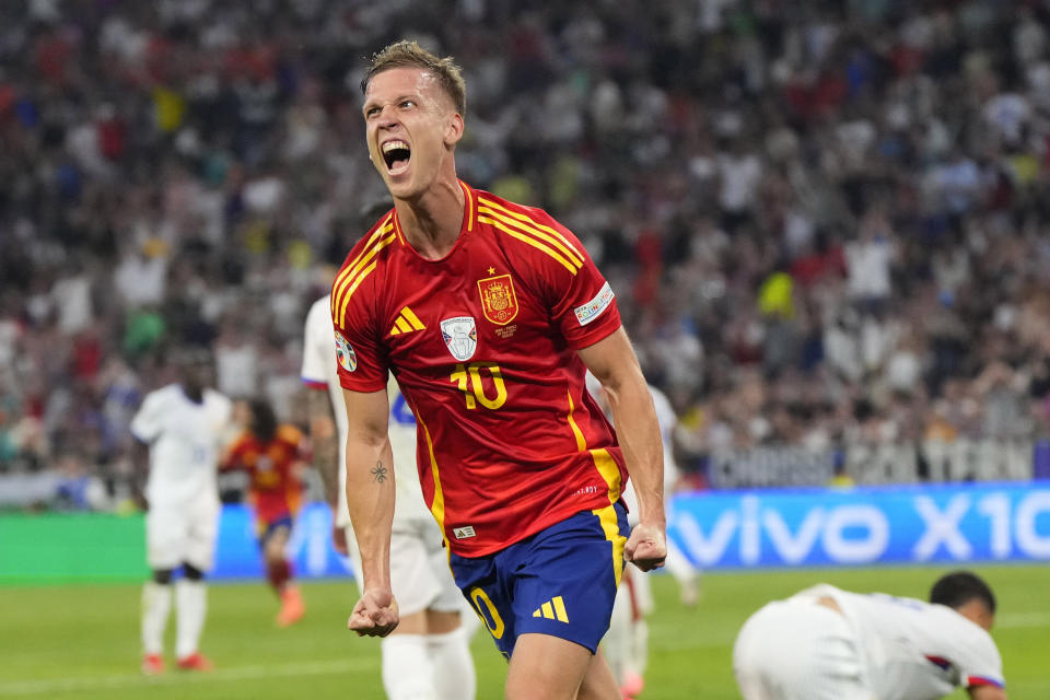Spain's Dani Olmo celebrates after scoring his side's second goal during a semifinal match between Spain and France at the Euro 2024 soccer tournament in Munich, Germany, Tuesday, July 9, 2024. (AP Photo/Manu Fernandez)