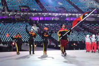 <p>Flag bearer Yohan Goncalves Goutt of Democratic Republic of Timor-Leste and his teammates wear red, yellow, and black color-block winter gear during the opening ceremony of the 2018 PyeongChang Games. (Photo: Quinn Rooney/Getty Images) </p>