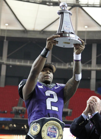 Dec 31, 2014; Atlanta , GA, USA; TCU Horned Frogs quarterback Trevone Boykin (2) hoist the offensive player of the game trophy following their 42-3 win over the Mississippi Rebels in the 2014 Peach Bowl at the Georgia Dome. (Brett Davis-USA TODAY Sports)