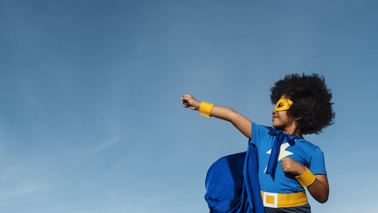 girl with afro playing superhero