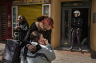 <p>A police officer stands guard as Maria Luisa Montiel, 47, cries during her eviction in Madrid, April 28, 2015. (AP Photo/Andres Kudacki) </p>