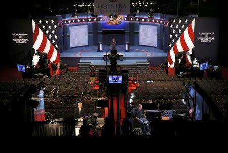 Workers on the stage prepare for the first presidential debate at Hofstra University in Hempstead, New York, U.S., September 26, 2016. REUTERS/Brian Snyder