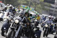 Motorcycle enthusiasts caravan through the streets of the city, in a show of support for President Jair Bolsonaro, in Sao Paulo, Brazil, Saturday, June 12, 2021. (AP Photo/Marcelo Chello)