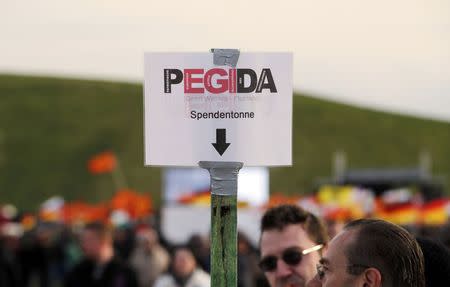 A sign, asking for donations, is seen as supporters of the movement Patriotic Europeans Against the Islamisation of the West (PEGIDA) gather for a speech of Dutch anti-Islam politician Geert Wilders during a rally in Dresden April 13, 2015. REUTERS/Fabrizio Bensch