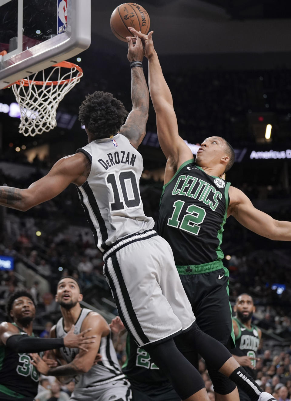 San Antonio Spurs' DeMar DeRozan (10) is fouled by Boston Celtics' Grant Williams during the first half of an NBA basketball game, Saturday, Nov. 9, 2019, in San Antonio. (AP Photo/Darren Abate)