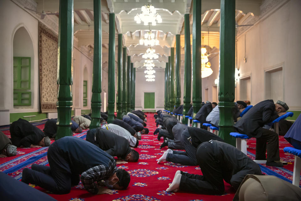 Uyghurs and other members of the faithful pray at the Id Kah Mosque in Kashgar in western China's Xinjiang Uyghur Autonomous Region, as seen during a government organized trip for foreign journalists, Monday, April 19, 2021. A human rights group is appealing to the United Nations to investigate allegations China's government is committing crimes against humanity in the Xinjiang region. Human Rights Watch cited reports of the mass detention of Muslims, a crackdown on religious practices and other measures against minorities in the northwestern region. (AP Photo/Mark Schiefelbein)