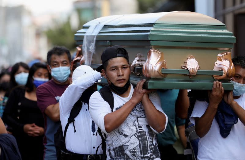 Relatives and friends carry the coffin of Daniel Arnulfo Perez along a street during his funeral, in El Tejar