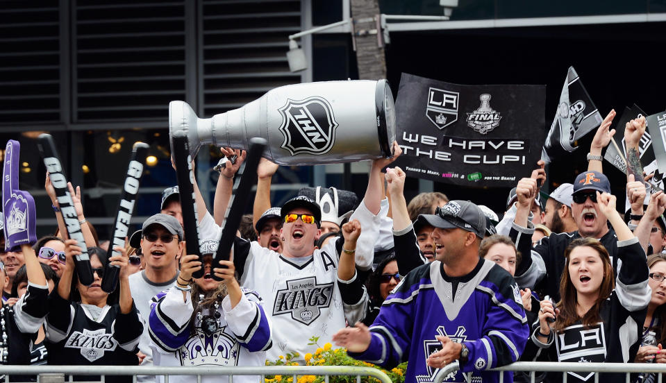 LOS ANGELES, CA - JUNE 14: Fans cheer during the Los Angeles Kings Stanley Cup victory parade on June 14, 2012 in Los Angeles, California. The Kings are celebrating thier first NHL Championship in the team's 45-year-old franchise history. (Photo by Kevork Djansezian/Getty Images)