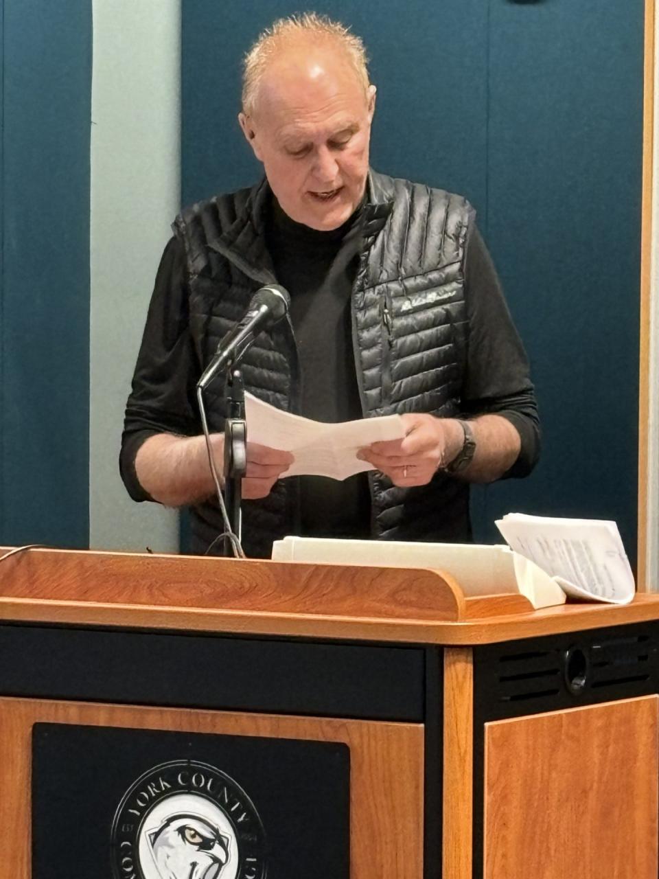 Richard Jorgensen reads a prepared statement during the Wells Select Board's public hearing for a proposed moratorium on large-scale housing projects on April 16, 2024. Jorgensen owns property on Post Road in Wells, Maine, that he is hoping to sell to a developer.