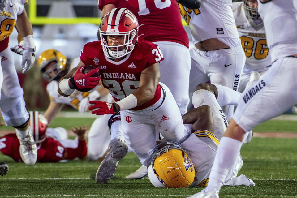 Indiana running back Chris Childers (36) is tackled by Idaho linebacker Tre Walker during the second half of an NCAA college football game Saturday, Sept. 11, 2021, in Bloomington, Ind. (AP Photo/Doug McSchooler)