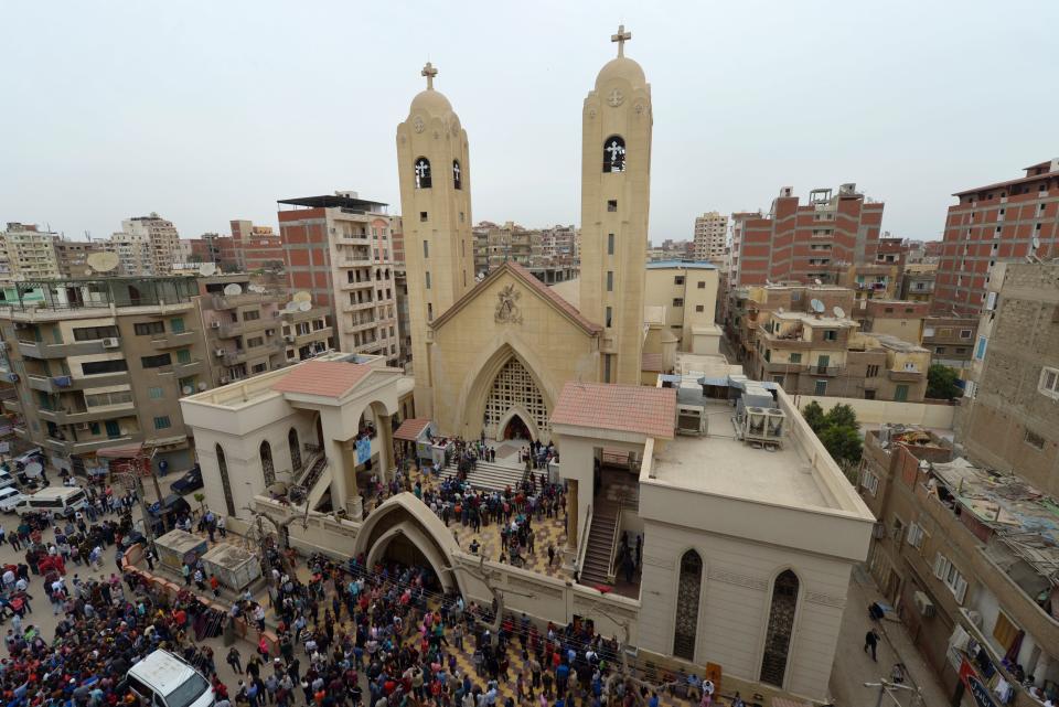 A general view shows people gathering outside the Mar Girgis Coptic Church in the Nile Delta City of Tanta after a bomb blast struck worshippers gathering to celebrate Palm Sunday on April 9, 2017.