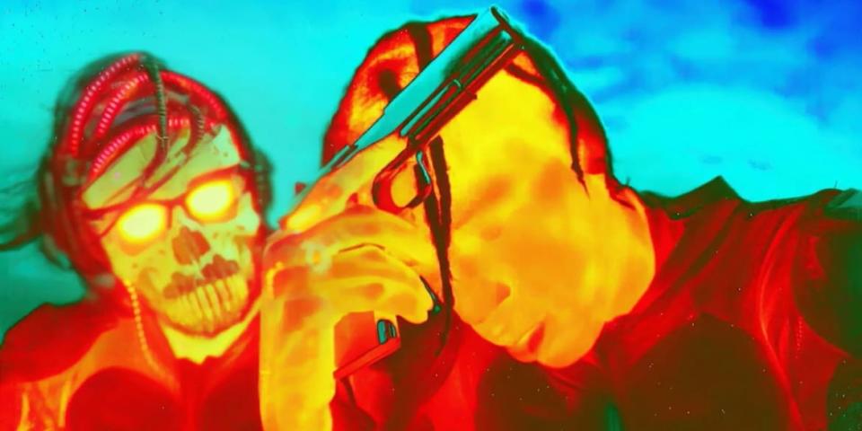 Travis Scott holds a gun in a still from ‘Aggro Dr1ft’