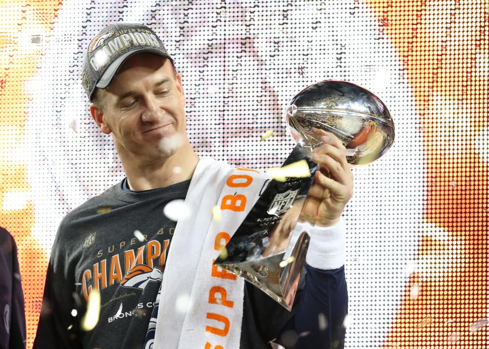 Feb 7, 2016; Santa Clara, CA, USA; Denver Broncos quarterback Peyton Manning (18) looks at the Vince Lombardi Trophy after beating the Carolina Panthers in Super Bowl 50 at Levi's Stadium. Mandatory Credit: Matthew Emmons-USA TODAY Sports