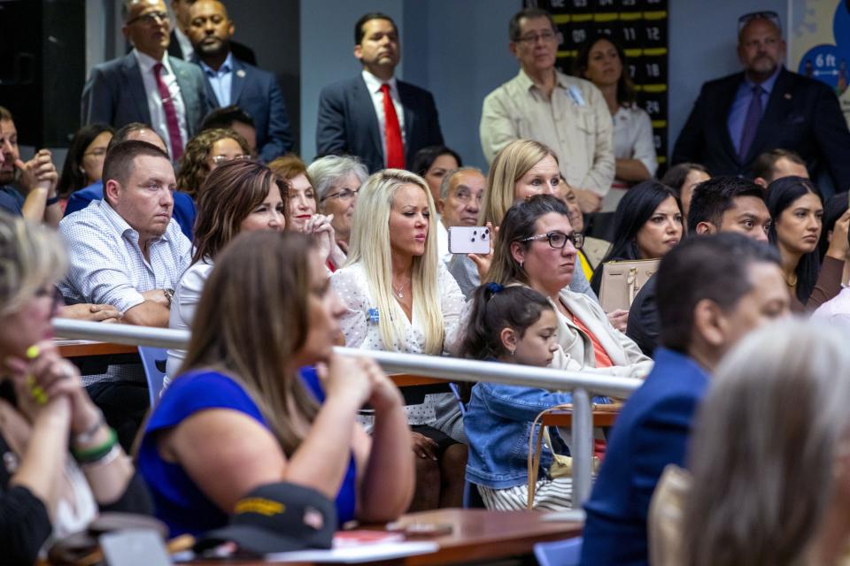 A crowd listens to Florida Gov. Ron DeSantis before he publicly signed HB7, "individual freedom," also dubbed the "stop woke" bill during a news conference at Mater Academy Charter Middle/High School in Hialeah Gardens, Fla., on Friday, April 22, 2022. DeSantis also signed two other bills into laws including one regarding the "big tech" bill signed last year but set aside due to a court ruling, and the special districts bill, which relates to the Reedy Creek Improvement District. (Daniel A. Varela/Miami Herald via AP)