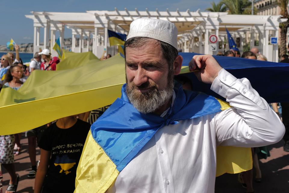 A man holds a Ukrainian flag at a demonstration in Nice, France, on 24 August, 2022. (AFP via Getty Images)