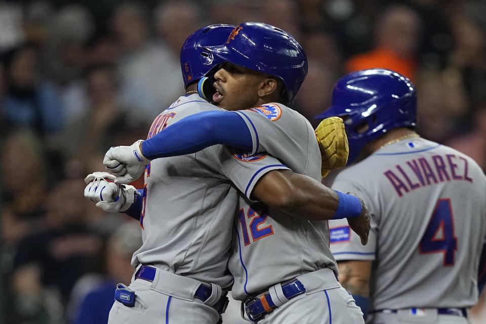 New York Mets' Francisco Lindor (12) celebrates with Starling Marte (6) after they and Francisco Alvarez (4) scored on Lindor's three-run home run against the Houston Astros during the third inning of a baseball game Monday, June 19, 2023, in Houston. (AP Photo/David J. Phillip)