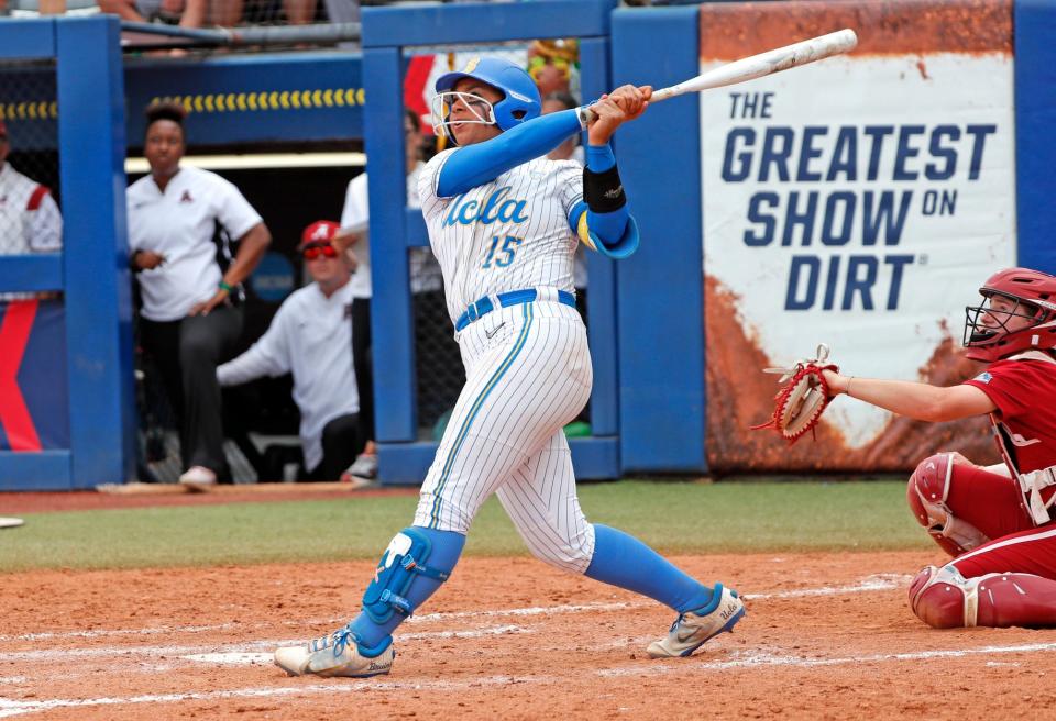 UCLA's Jordan Woolery hits a three-run homer in the sixth inning against Alabama in Game 1 of the 2024 Women's College World Series.