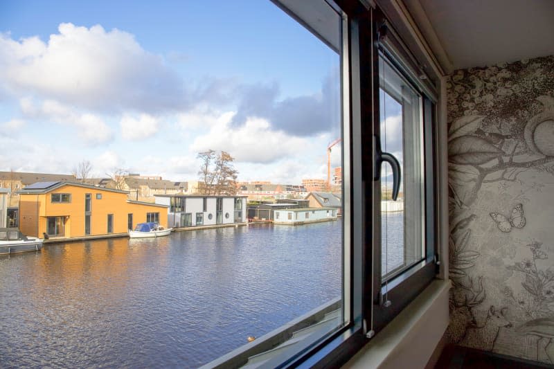 View of water from neutral bedroom on houseboat.