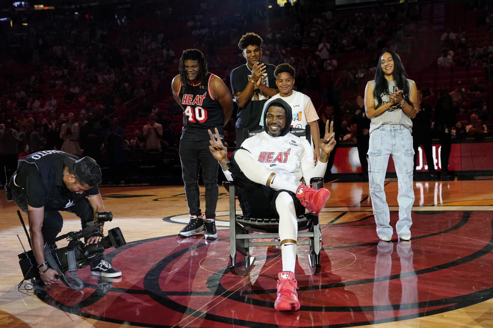 Miami Heat forward Udonis Haslem sits in a rocking chair given to him during a ceremony before an NBA basketball game against the Orlando Magic, Sunday, April 9, 2023, in Miami. Haslem's final regular-season game with the Heat is Sunday. (AP Photo/Lynne Sladky)