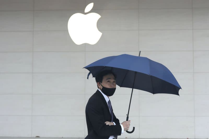 FILE PHOTO: A man walks past an Apple store in Taipei