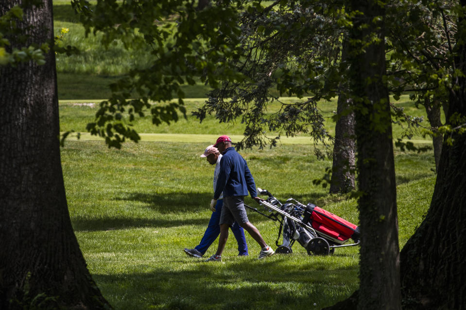 Golfers walk on the green at the Sligo Creek Golf Course in Silver Spring, Md., Monday, May 11, 2020, as Maryland Gov. Larry Hogan opened golf courses in the initial stage in easing coronavirus shutdown. As states push for some return to normal business operations, elected officials in the Virginia and Maryland suburbs surrounding Washington, D.C., are unwilling to quickly reopen, as they confront COVID-19 infection and fatality numbers that are the highest in their states. (AP Photo/Manuel Balce Ceneta)