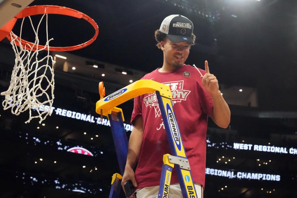 Alabama guard Mark Sears cuts the net after defeating Clemson in the finals of the West Regional of the 2024 NCAA Tournament at Crypto.com Arena.