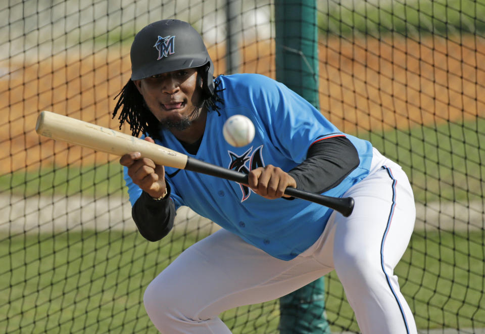 FILE - In this Feb. 12, 2020, file photo, Miami Marlins pitcher Sixto Sanchez run drills during spring training baseball practice in Jupiter, Fla. For a number of rebuilding teams, the 2020 baseball season was supposed to be another step in the progression of their top prospects eventually reaching the big leagues. With a truncated 60-game season in the majors and no minor league season expected, some clubs are concerned that the development of top prospects may be stunted. (David Santiago/Miami Herald via AP, File)