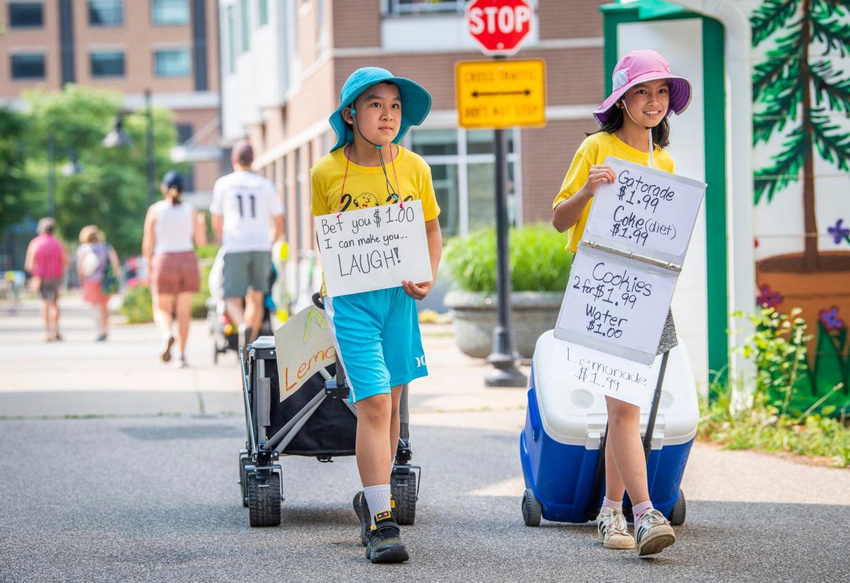 Mikko Liu, left, offers jokes as his sister Mili Liu offers lemonade and other refreshments in their mobile stand along the B-Line Trail during Lemonade Day in Monroe County on Saturday, June 24, 2023.