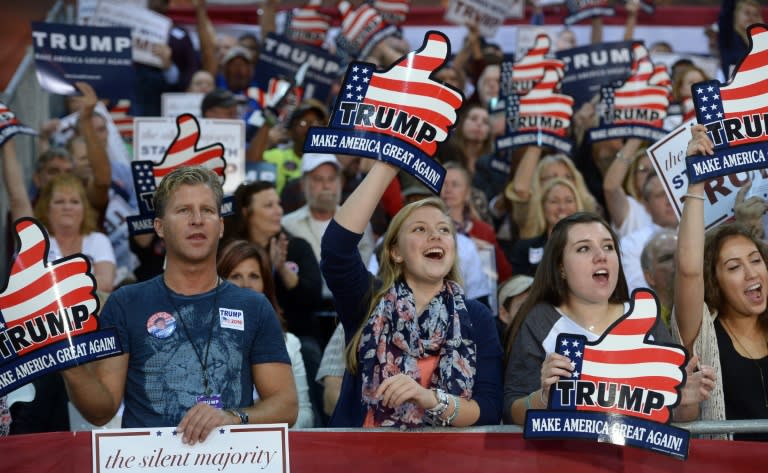 Supporters of Republican presidential candidate Donald Trump wave banners during a rally on October 14, 2015 in Richmond, Virginia