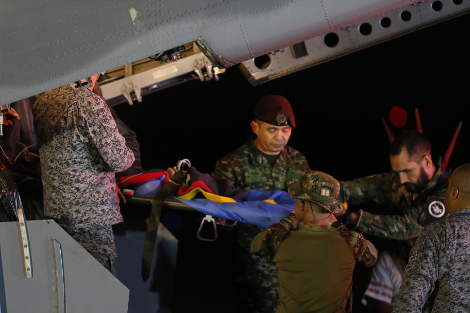 CORRECTS BROTHERS TO CHILDREN - Military personnel unload from a plane one of four Indigenous children who were missing after a deadly plane crash at the military air base in Bogota, Colombia, Saturday, June 10, 2023. The children survived a small plane crash 40 days ago and had been the subject of an intense search in the jungle. (AP Photo/John Vizcaino)