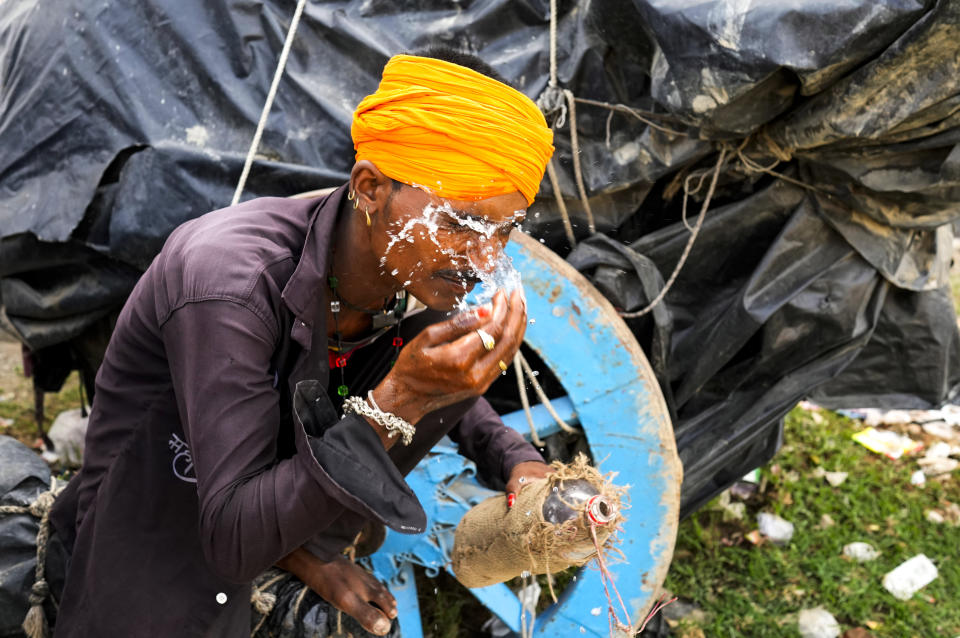 A man splashes water on his face to cool himself on a hot summer afternoon in Lalitpur district in northern Uttar Pradesh state, India, Sunday, June 18, 2023. Swaths of two of India's most populous states are under a grip of sever heat leaving dozens of people dead in several days as authorities issue a warning to residents over 60 and others with ailments to stay indoors during the daytime. (AP Photo/Rajesh Kumar Singh)