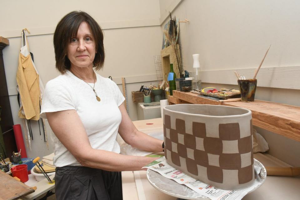 Artist Sandy Patton works on a ceramic piece at River Oaks Square Arts Center that will be part of the River Oaks resident artists' show coming up in June that will celebrate River Oaks' 40th anniversary. Patton's piece has 40 squares reflecting the anniversary.