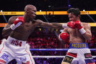 Yordenis Ugas, of Cuba, hits Manny Pacquiao, of the Philippines, in a welterweight championship boxing match Saturday, Aug. 21, 2021, in Las Vegas. (AP Photo/John Locher)