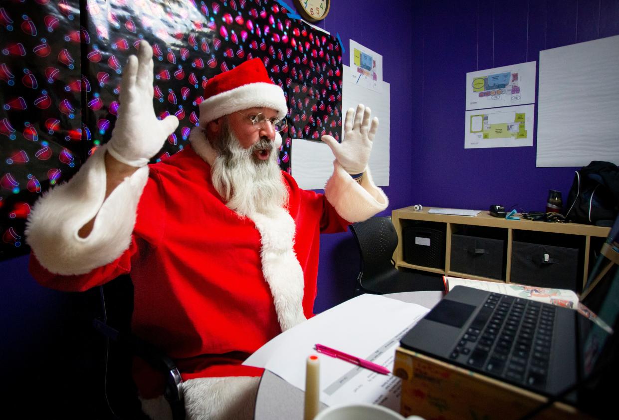 Santa, with some help from Corey Anderson, says goodbye to a child with a hearty "Ho, ho, ho!" during a Dec. 13 Zoom with Santa session at the Eugene Family YMCA.