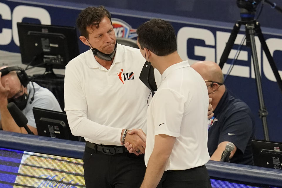 Utah Jazz head coach Quin Snyder, left, shakes hands with Oklahoma City Thunder head coach Mark Daigneault, right, following their NBA basketball game Friday, May 14, 2021, in Oklahoma City. (AP Photo/Sue Ogrocki)