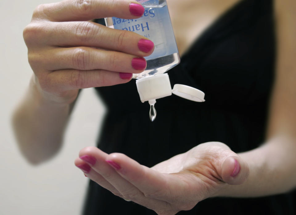 Woman Applying Hand Sanitiser