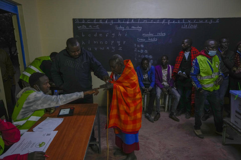 Residents line up to vote at the Oltepesi Primary School in Kajiado County, Nairobi, Kenya, Tuesday Aug. 9, 2022. Kenyans are voting to choose between opposition leader Raila Odinga and Deputy President William Ruto to succeed President Uhuru Kenyatta after a decade in power. (AP Photo/Ben Curtis)