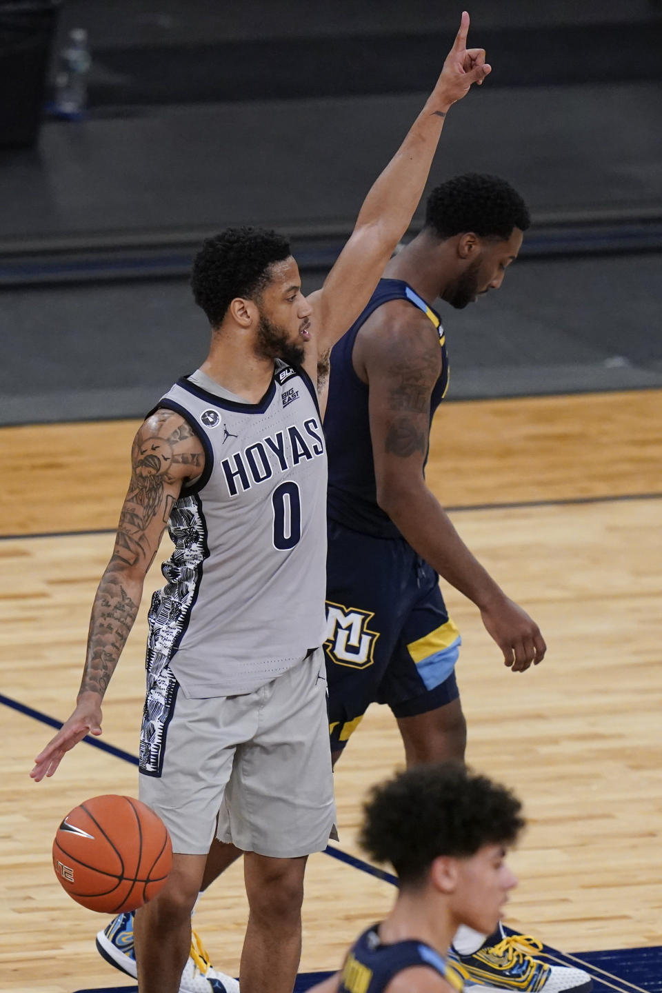Georgetown's Jahvon Blair, left, gestures as Marquette's Symir Torrence, right, leaves the court after an NCAA college basketball game in the Big East conference tournament Wednesday, March 10, 2021, in New York. Georgetown won 68-49. (AP Photo/Frank Franklin II)