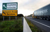 FILE PHOTO: A Guinness truck passes a sign for Customs and Excise on a road near the border with Ireland near Kileen, Northern Ireland, October 17, 2018. REUTERS/Clodagh Kilcoyne/File Photo