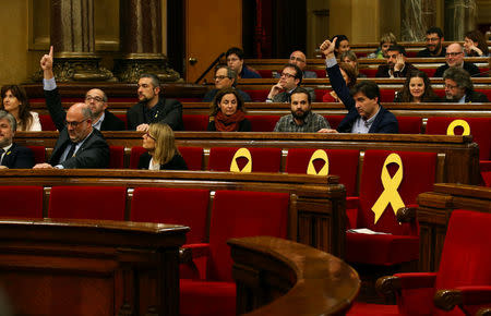 Parties' spokesmen signal their position ahead of the vote during a plenary session of the Catalonia's regional parliament in Barcelona, Spain, March 28, 2018. REUTERS/Albert Gea