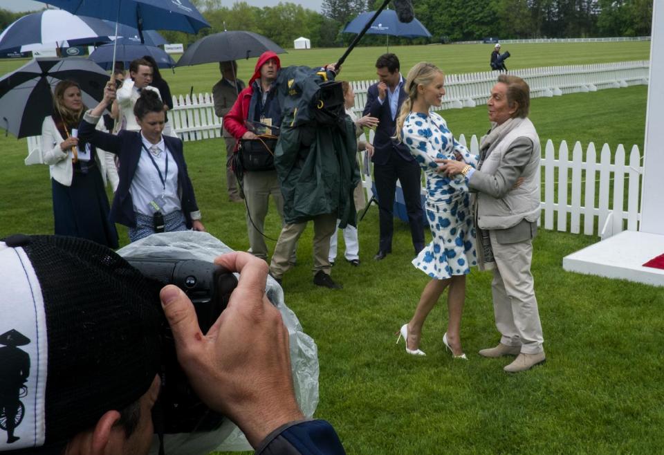 Model Karolina Kurkova greets fashion designer Valentino before the Sentebale Royal Salute Polo Cup charity match in Greenwich, Conn., Wednesday, May 15, 2013, where Britain's Prince Harry will participate. (AP Photo/Craig Ruttle)